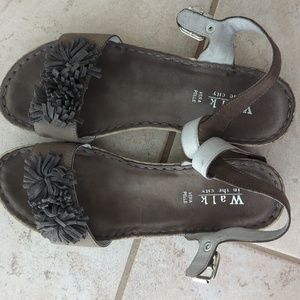 Dark taupe suede sandals with fringe flowers on top, across toe band